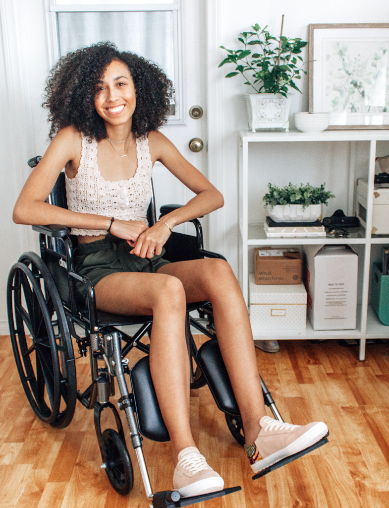 Girl in Wheelchair Smiling Wearing PANAFRICA Blush Colored Sneakers