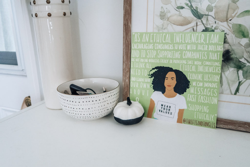 black and white pumpkin on entryway table with illustration of thrifts & tangles and a speckled bowl